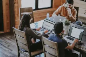 employees engaged and working together on their lap tops