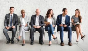 3 men and 3 women sitting in chairs next to each other