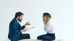 Man and woman sitting across from teach other talking with emotion