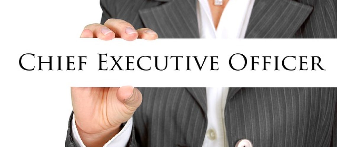 woman holding a CEO sign