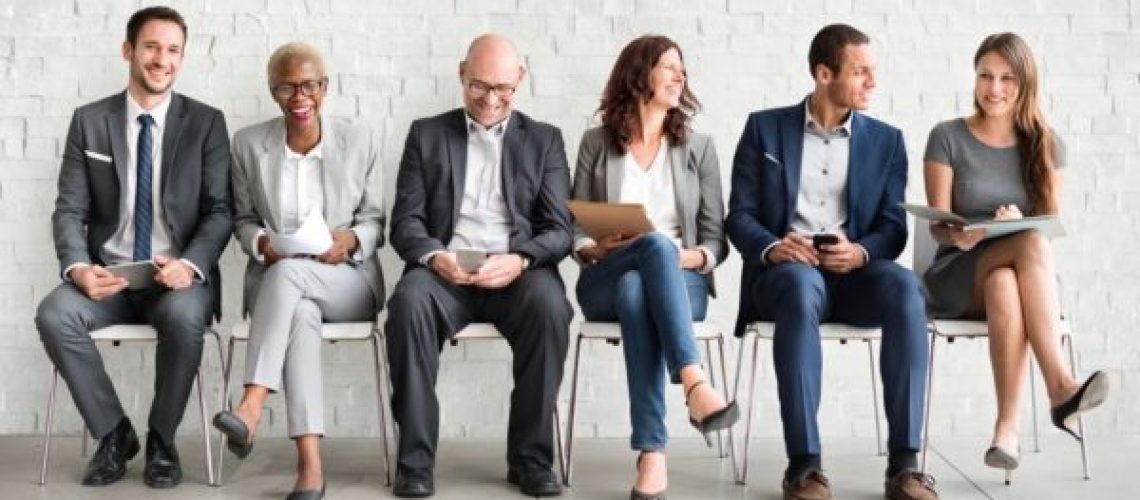 3 men and 3 women sitting in chairs next to each other
